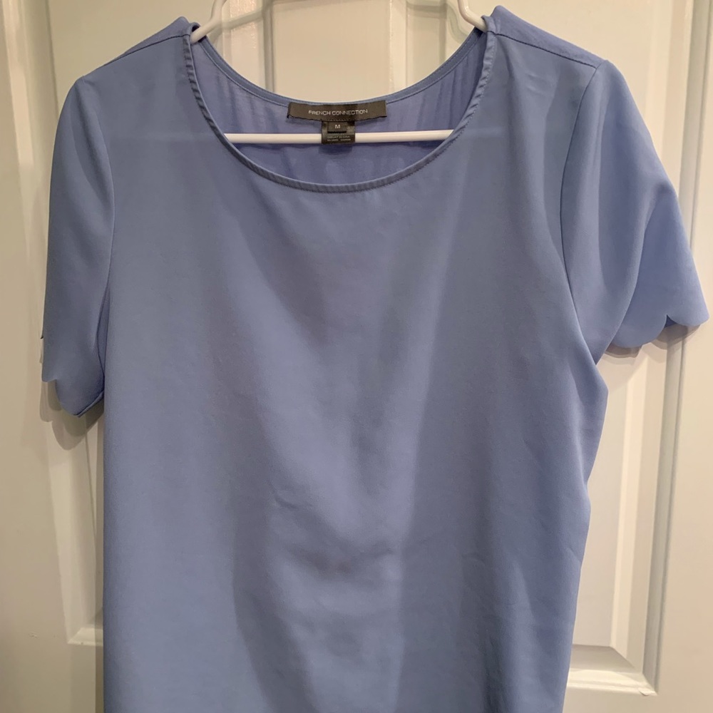 Periwinkle blouse with scalloped sleeves and trim